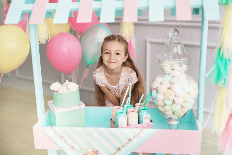 little girl enjoying snack bar at birthday party 