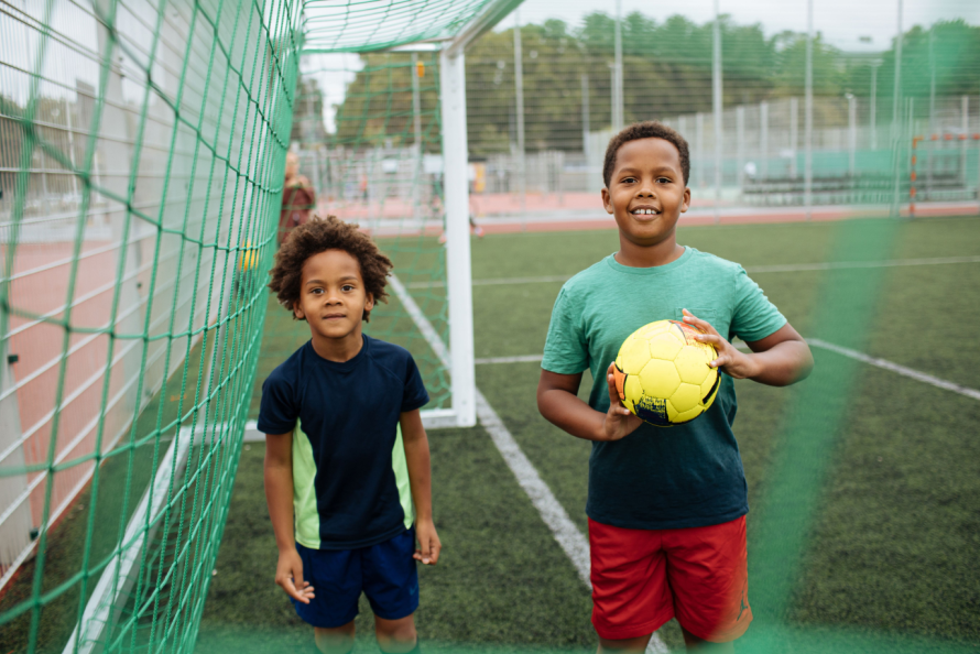 Two kids playing soccer game