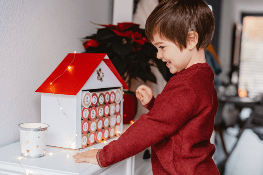 Child looking at holiday gift advent calendar