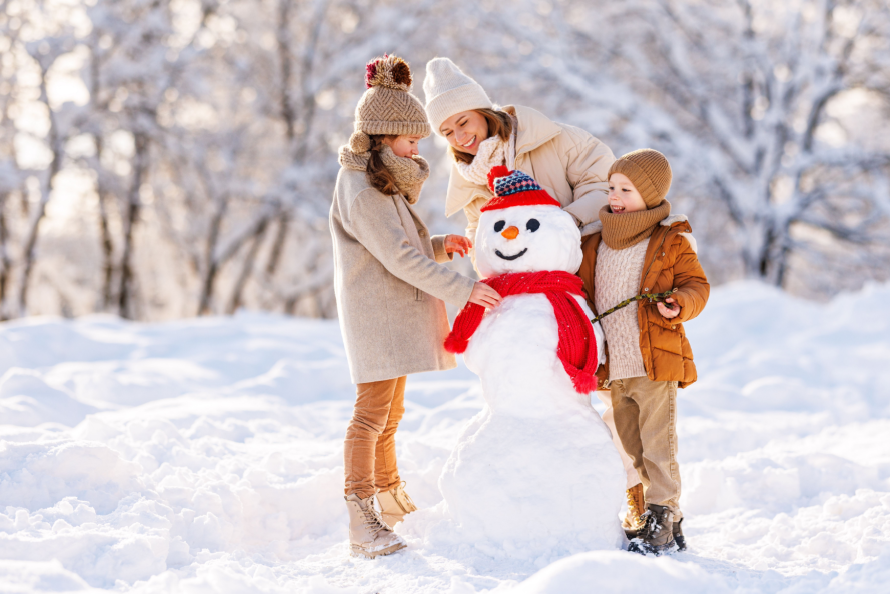 Family making snowman winter activity