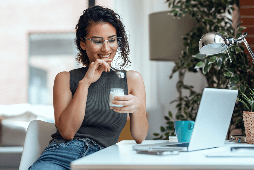 woman eating a snack at her desk
